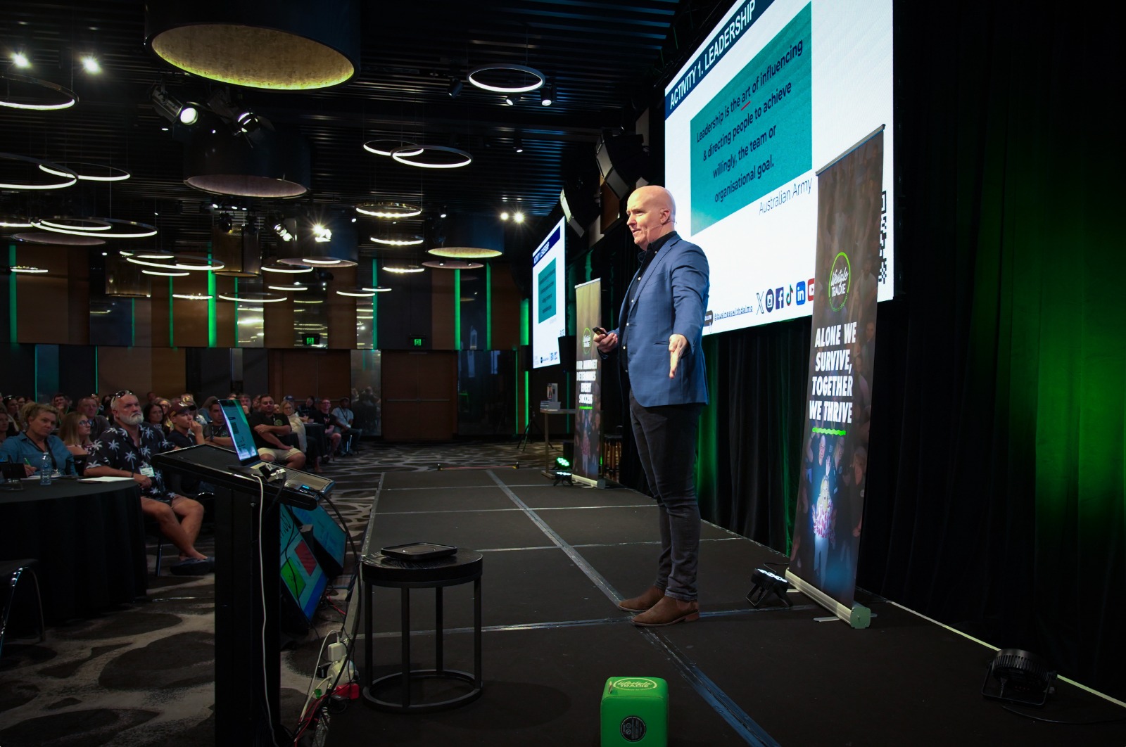 Daimien Patterson on stage presenting to business owners
