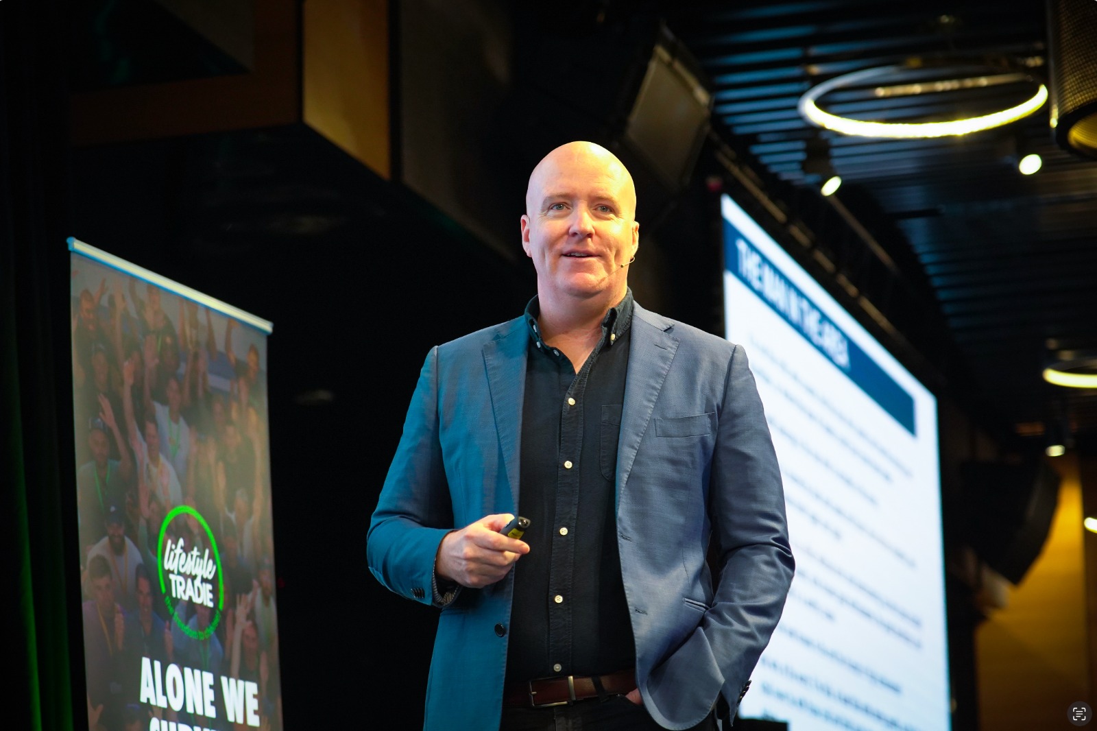 Daimien Patterson on stage at a business event